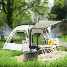 an image of a tent set up in the grass with food and drinks on it