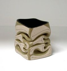 a black and white vase sitting on top of a table