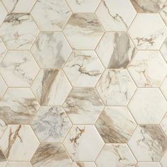 a white and brown tile pattern with hexagonal tiles