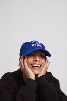 a smiling woman wearing a blue hat with the words we are worth written on it