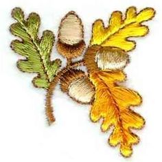 an embroidered leaf and acorn on a white background