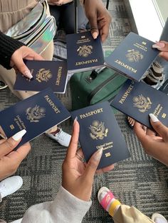 several people holding up their passport cards