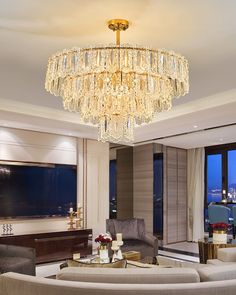 a living room filled with furniture and a large chandelier hanging from the ceiling