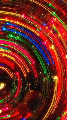 colorful lights are in the middle of a circular object with circles and dots on it