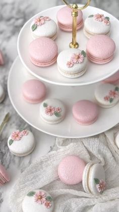 three tiered plate with pink and white macaroons