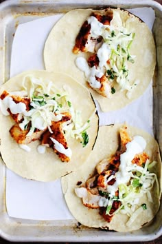 four tortillas with chicken, lettuce and sour cream on them