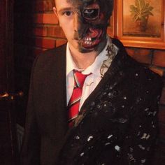 a man in a suit and tie with makeup on his face