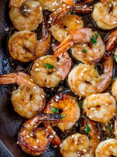 cooked shrimp with sauce and garnish in a pan