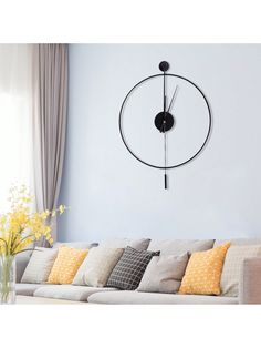 a living room filled with furniture and a large clock on the wall above it's head