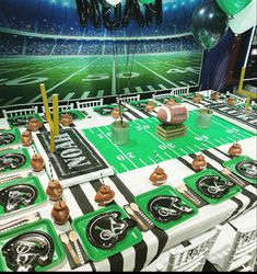 a football themed party table set up with balloons