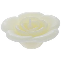 a candle that is sitting in the shape of a flower