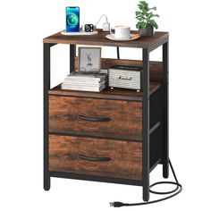 an end table with two drawers and a phone on top, next to a potted plant