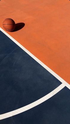 an orange and blue court with a basketball in the air on it's side