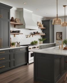 a kitchen with gray cabinets and gold accents