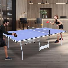 two people playing ping pong in an office setting