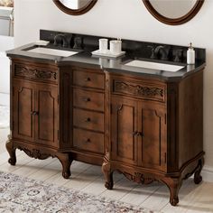 a double sink vanity with two mirrors and a rug on the floor next to it