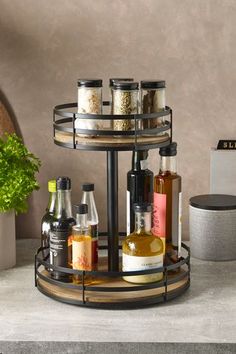 a round shelf with bottles and spices on it