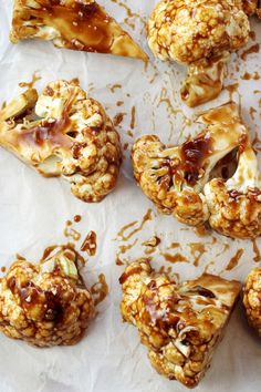 several pieces of food sitting on top of a piece of wax paper covered in caramel