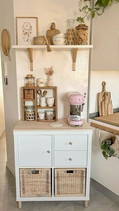 a kitchen with white cabinets and wicker baskets