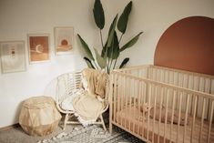 a baby crib and chair in a small room