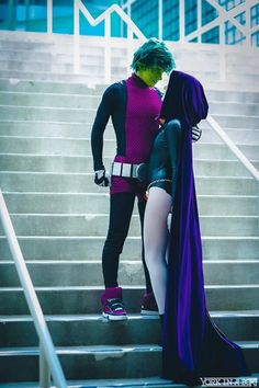 two people in costumes standing on some stairs