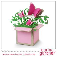 an origami flower box with pink flowers in it and green leaves on top