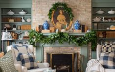 a living room filled with furniture and a fire place under a painting on the wall