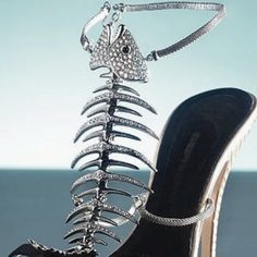 a high heeled shoe with a skeleton on the side