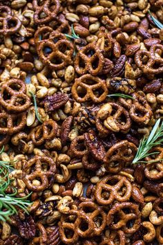 nuts and rosemary sprigs are mixed together