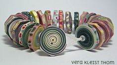 a close up of many different types of ribbons on a white surface with the words vera kerstt thomas