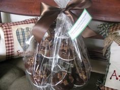 a basket filled with cookies sitting on top of a wooden bench next to pillows and pillow