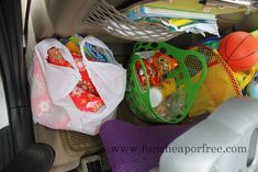 the back seat of a car is filled with toys and other items, including basketballs