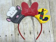 a mickey mouse ears headband is shown on a wooden surface