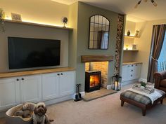 a living room filled with furniture and a flat screen tv mounted above a fire place