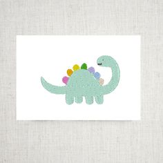 a green dinosaur with multicolored flowers on it's head is shown in front of a white background