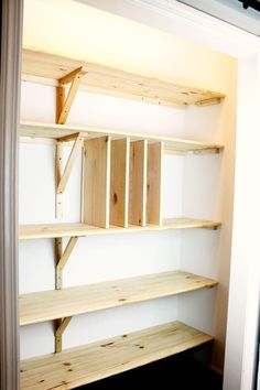 empty wooden shelves in the corner of a room