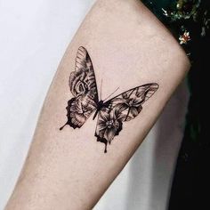 a small butterfly tattoo on the arm