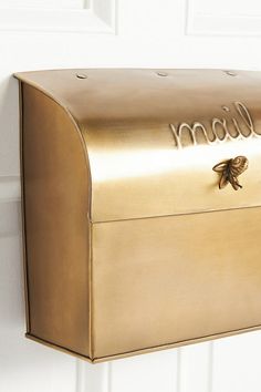 a gold mailbox with the word mom written on it