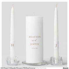 two white candles are next to each other with the names of their wedding guests on them