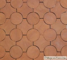 a close up view of a wall made out of wood circles and round holes on it