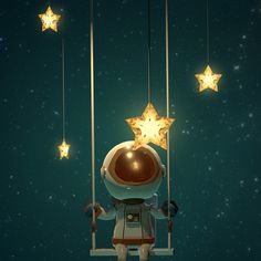 a little boy is sitting on a swing with stars hanging from the strings above him