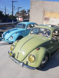 two old cars are parked next to each other