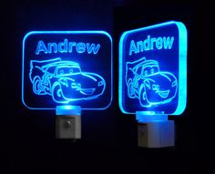 two illuminated signs with cars on them in the dark