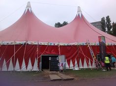 a large pink tent with white and red stripes