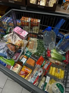 a shopping cart filled with food and drinks