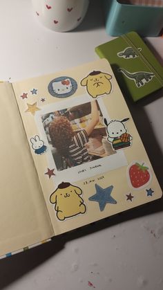 an open book with pictures and stickers on it