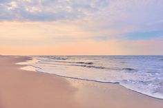 a beach with waves coming in to the shore