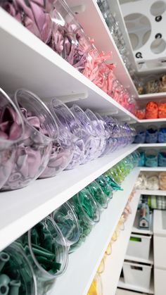 the shelves are filled with many different colored items