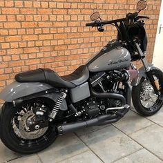 a motorcycle parked in front of a brick wall