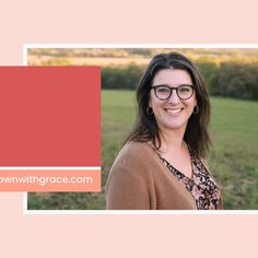 a woman wearing glasses standing in front of a field